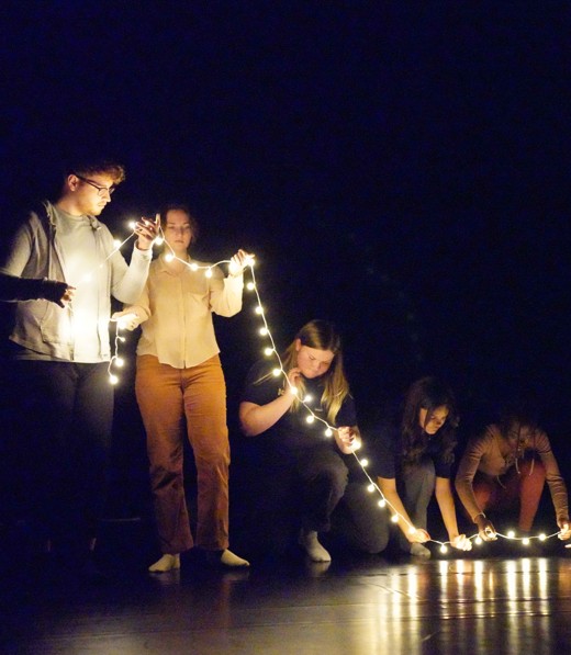 a string of lights held by a line of people