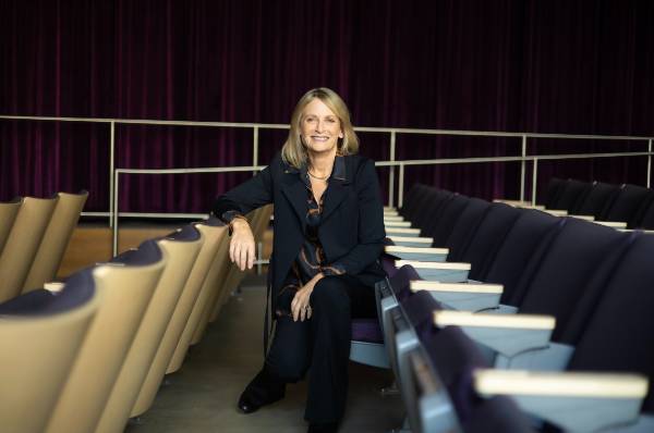 president beth dobkin seated in a row of auditorium chairs