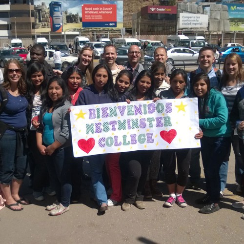 group of young peruvian students with sign