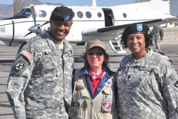 Betty Easley with veterans in front of plane