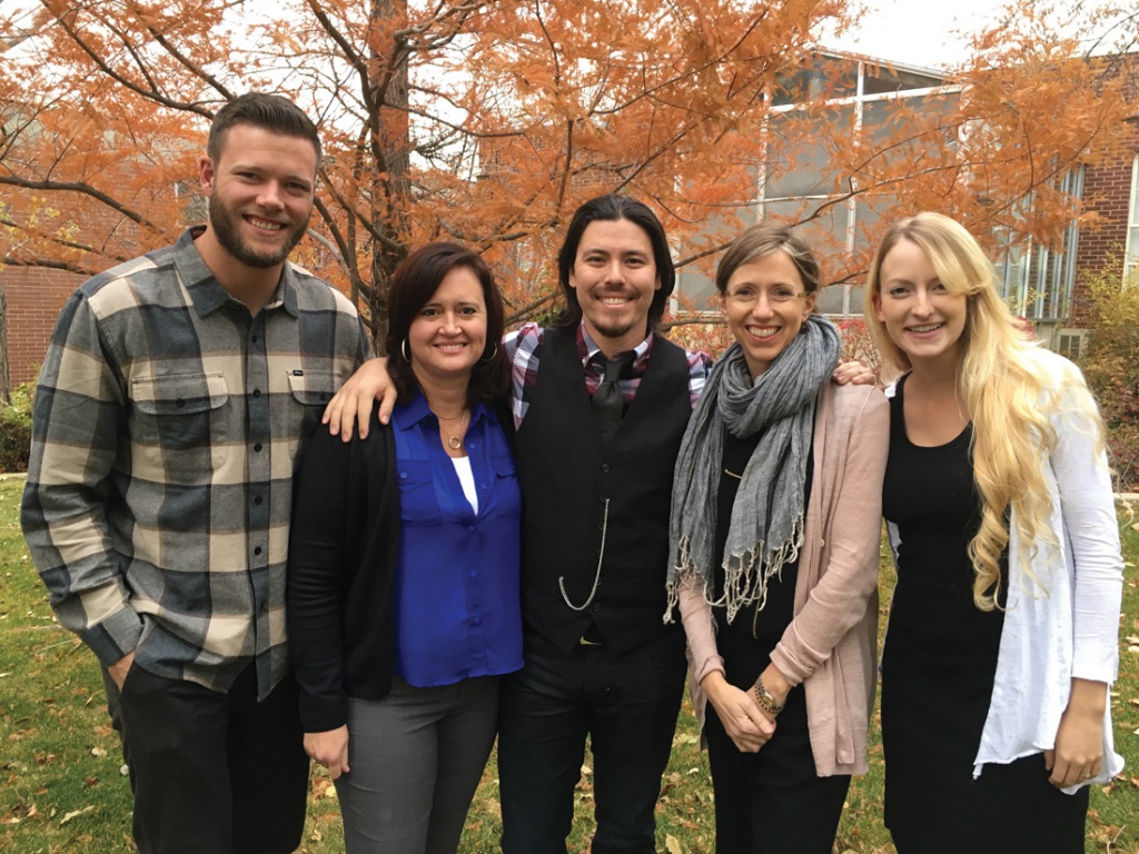 Jacob Jobe and others in front of fall foliage