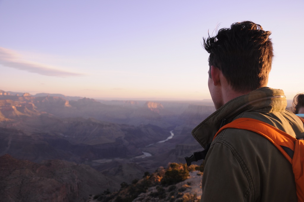 student overlooking mountain valley