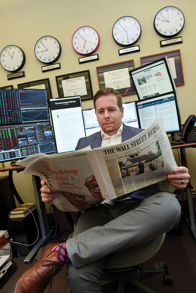 Jason Ware in office reading newspaper