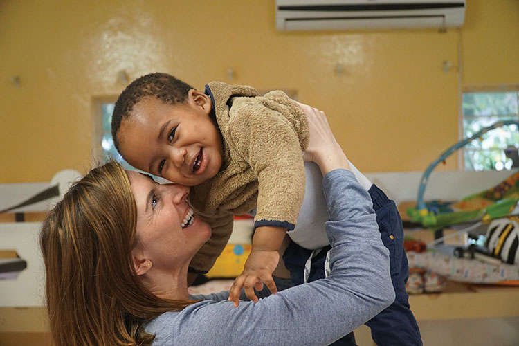 Brenna Riggers holding small child