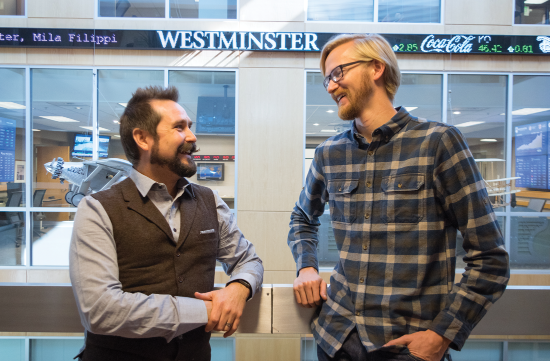 Westminster alumni Mitch Dumke and Porter Williams talking to each other inside the Gore School of Business building.