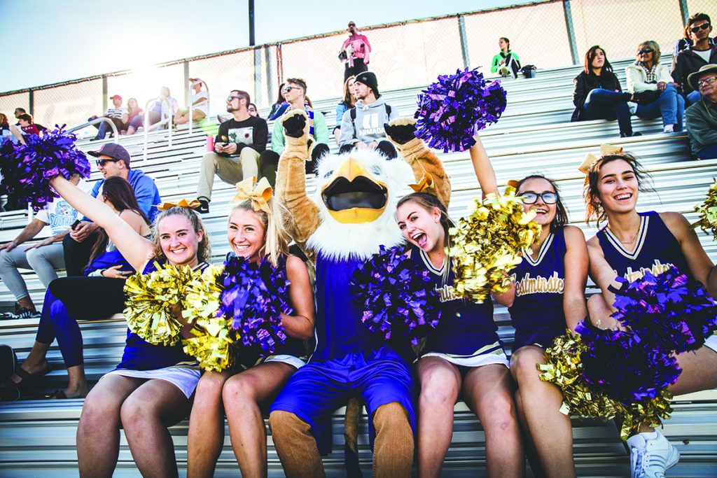 Westminster cheerleaders and mascot in bleachers