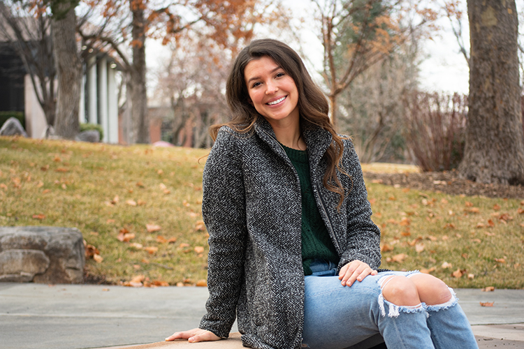 Taylor Discher posing outside in the fall