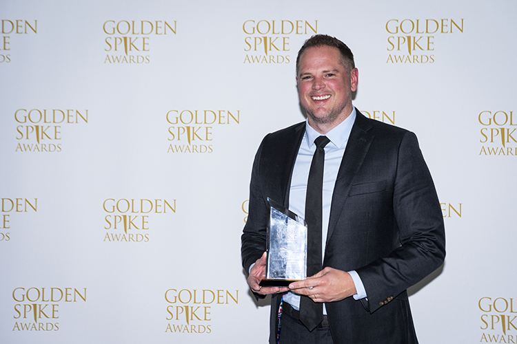 Kevin Randall holds his Golden Spike Award