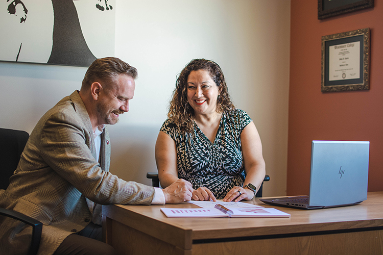 Silvia and Edward sit in an office at the Suazo Business Center