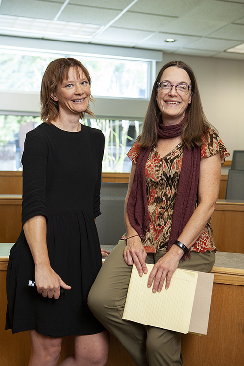 Connie Etter, PhD, and Julie Steward, PhD, stand in a classroom and face the camera