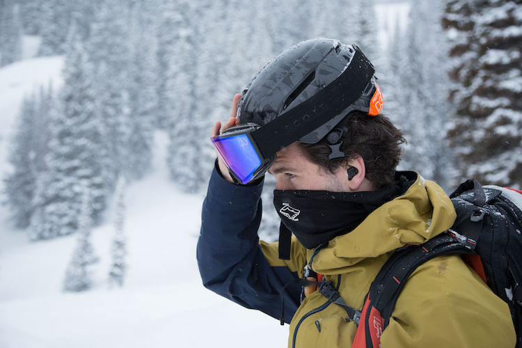 a guy with ski goggles in the mountains