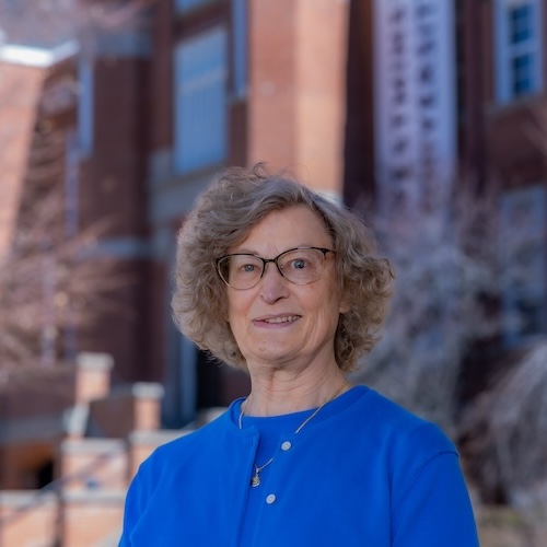 Peggy Cain in front of Converse Hall