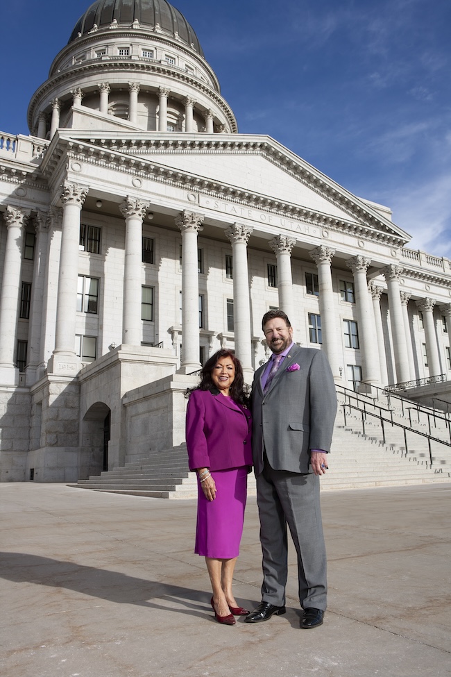 Josie Valdez and Mark Archuleta Wheatley in front of a stone building