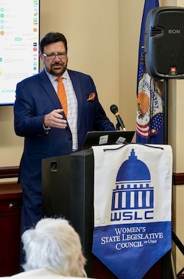 man standing at a podium indoors